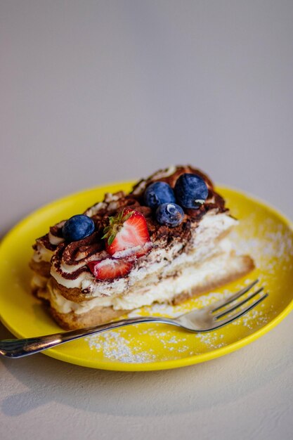 Blueberry cake on yellow plate photo