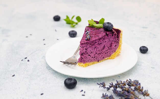 Blueberry cheesecake with fresh fruits, rosemary, and mint