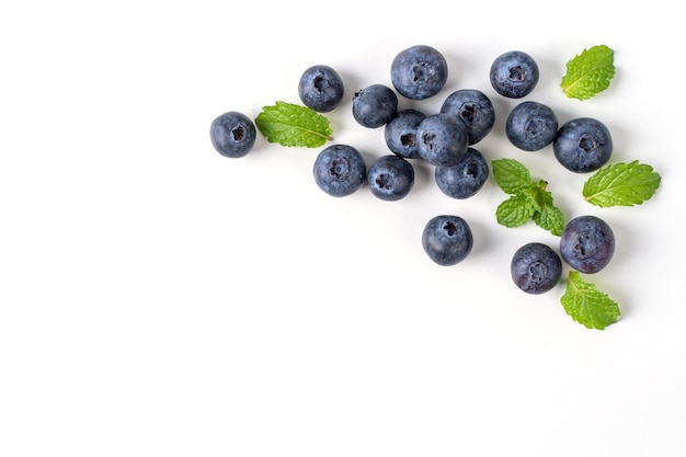 Blueberry fruit top view isolated on a white background, flat lay overhead layout with mint leaf