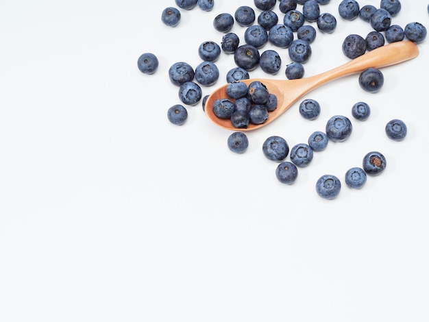 Blueberry fruit vitamins in a wooden spoon