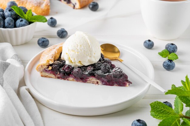 写真 ブルーベリーガレットのオープンパイまたはタルト、アイスクリームと紅茶添えサマースイートパイ