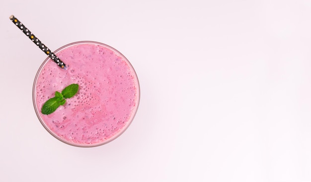 Blueberry milk smoothie on a white background Top view Copy space