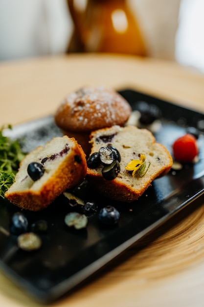 Blueberry muffins on black plate