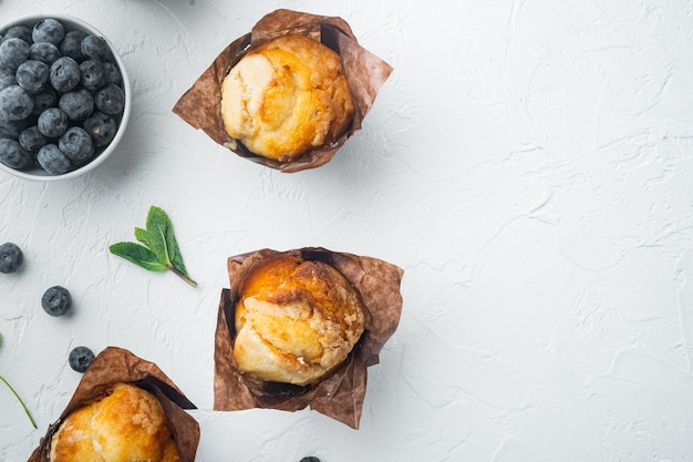 Blueberry muffins, on white table, top view flat lay