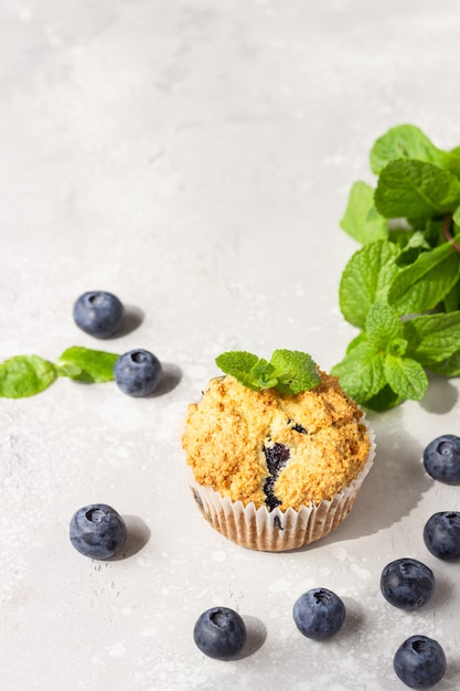 Blueberry muffins with fresh berries and mint