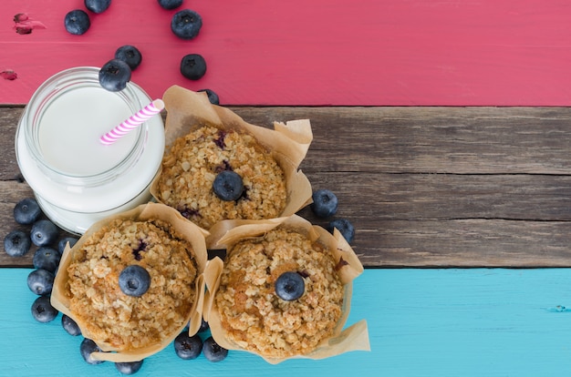 Blueberry muffins with milk on a table