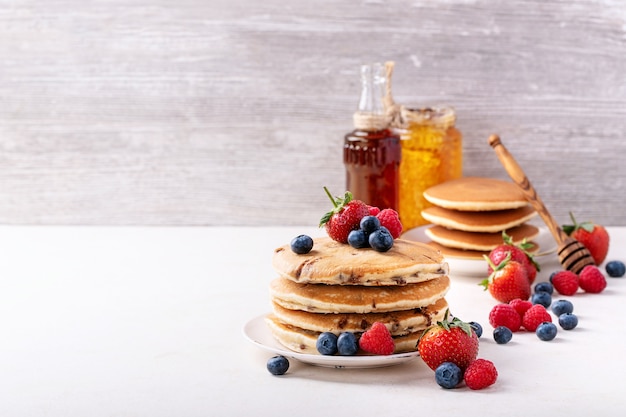 Blueberry pancakes served with honey