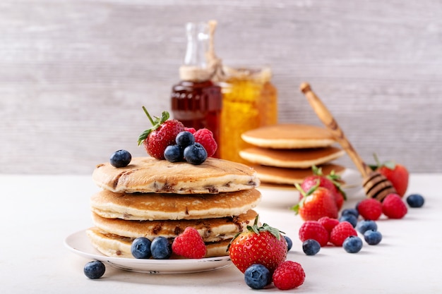 Blueberry pancakes served with honey