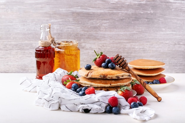 Blueberry pancakes served with honey