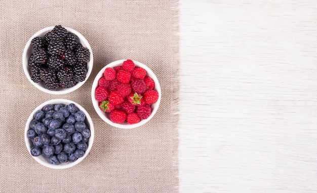 Blueberry, raspberry and blackberry in white bowl