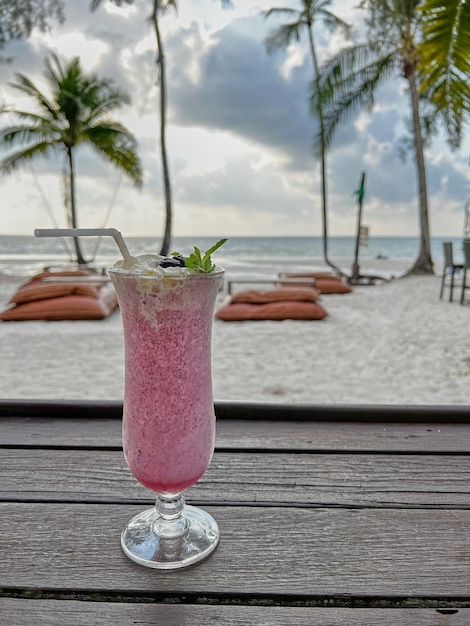 Photo blueberry smoothies on the table with front of seashore koh kood thailand