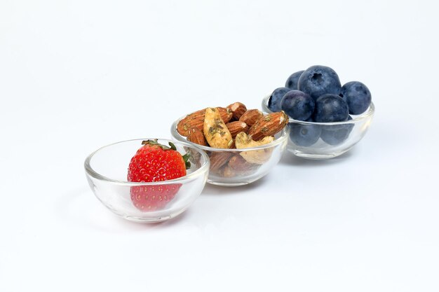 Blueberry Strawberry Herb Spice Almond Cashew Nut in glass bowl on white background