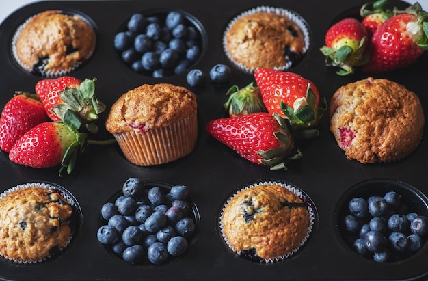 Blueberry and strawberry muffins with berries Close up Top view