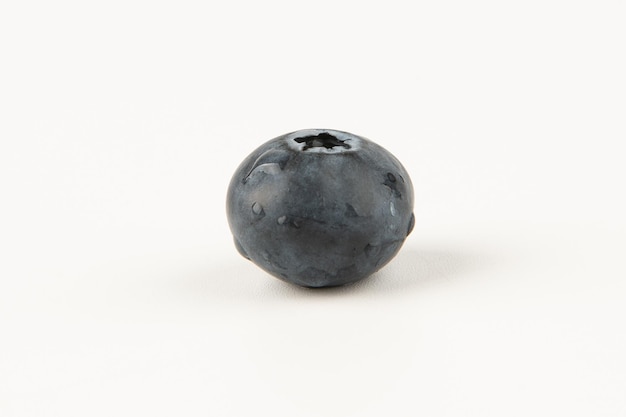 A blueberry on a white background.