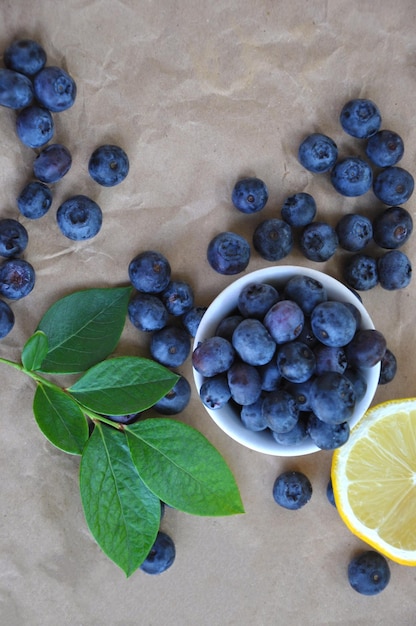 blueberry with green leaves and lemon slice top view