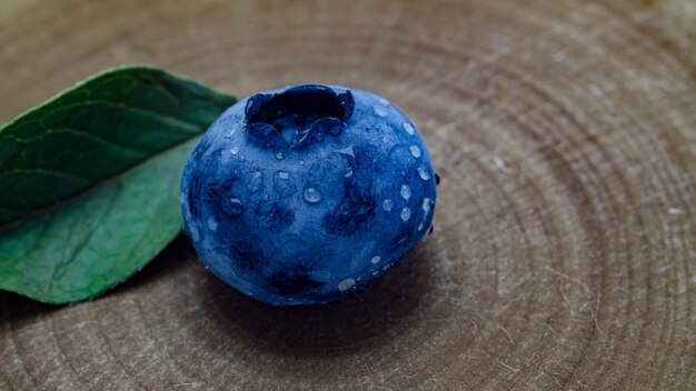 blueberry with leaf on a wooden background