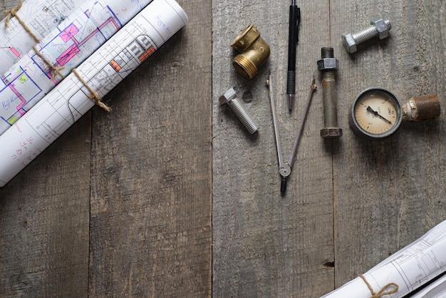 Blueprints internal screws bolts manometer pen on old wooden table