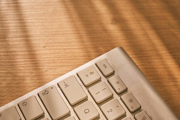 Bluetooth keyboard closeup on a wooden table. Communication banner.