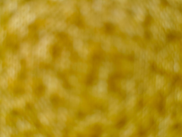 Blur abstract background of yellow fabric texture