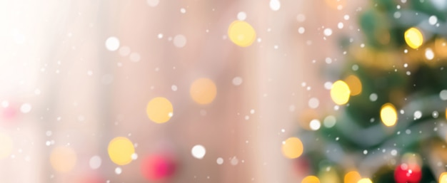 Photo blur christmas tree with snow and bokeh from decorative light