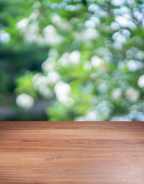 Blur green bokeh light outdoor natural garden with wooden floor Green natural Blur background