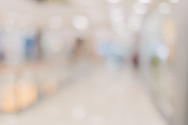 blur image background of hall in shopping mall with people