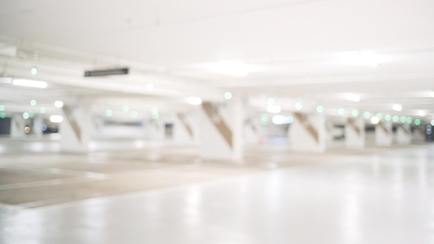 Photo blur image of empty car park in basement of garage shopping mall defocused interior background concept