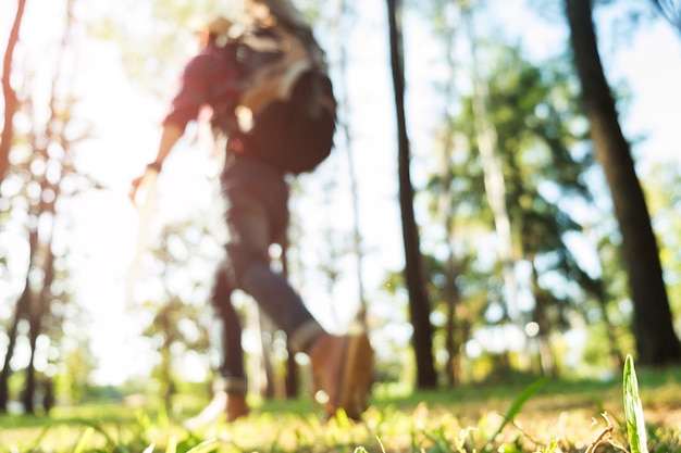 blur image of traveler with backpack relaxing outdoor on Summer vacations