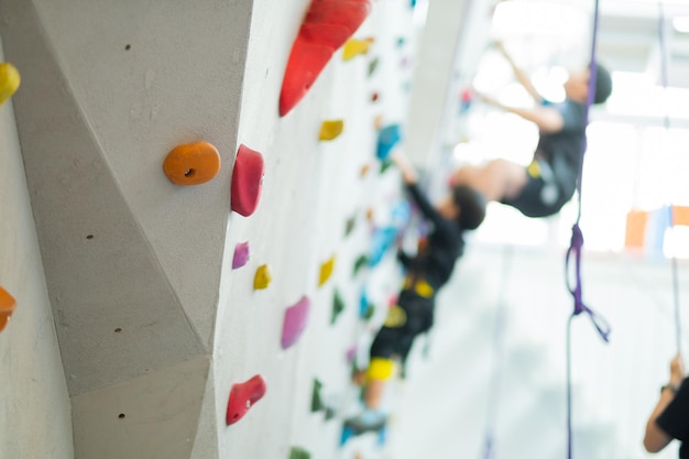 blur kid climbing a wall , children rock climbing