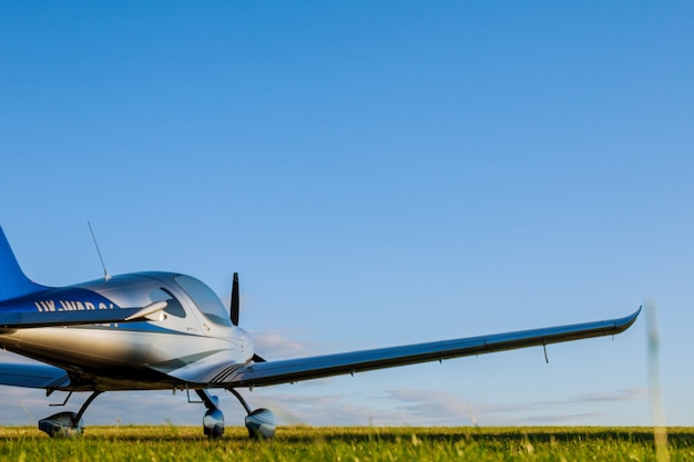 Blur Light small plane on a grass field