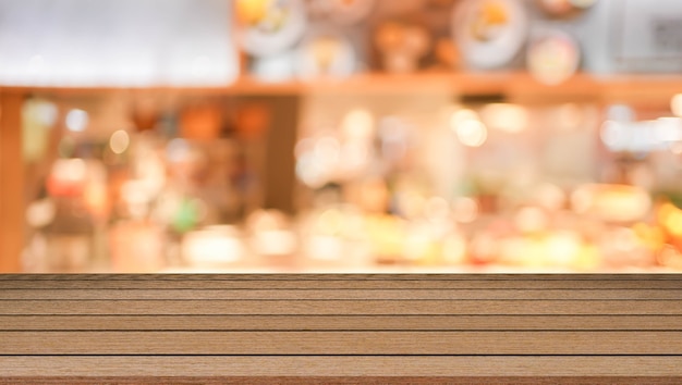 blur modern interior of cafe restaurant with circle bokeh light and modern wood table perspective