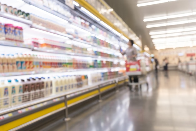 Blur of people buying with drinks  shelf product in Supermarket .For healthy concept