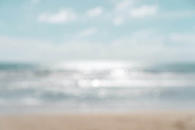 Blur summer bokeh beach with sun light and blue sky.