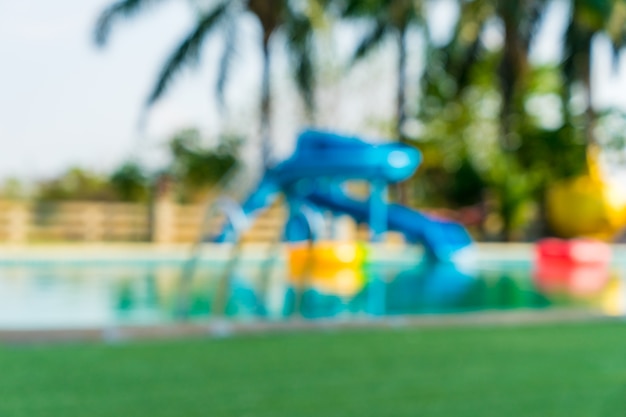 blur of swimming pool with blur of water slide background