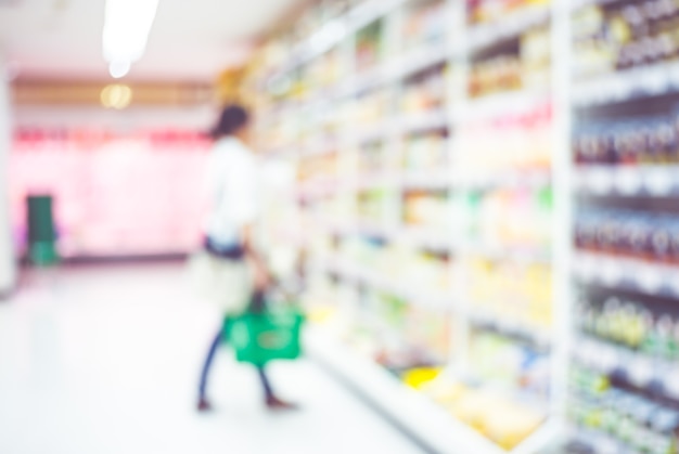 Blur woman customer select product on shelf in supermarket