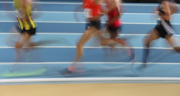 Photo blured athletes run in track and field