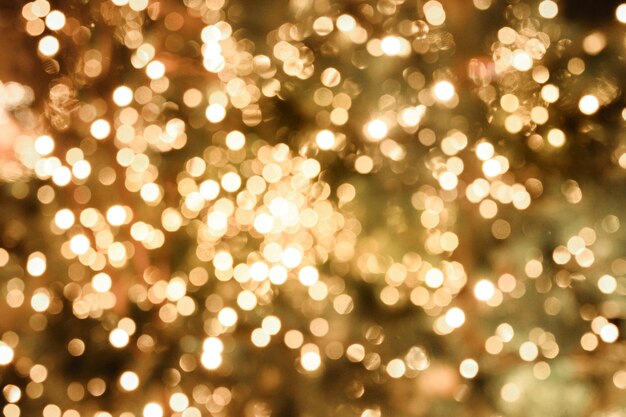 Photo blurred abstract background with defocused golden garland