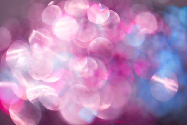 Blurred abstract pink glitter texture, defocused christmas lights. Holiday christmas concept.