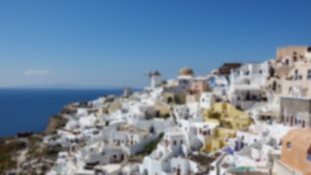 Blurred of Architecture with windmills on a hillside in Oia village on Santorini island, Greece Mediterranean sea.