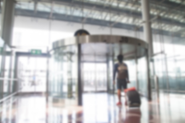 Blurred background of backpacker with luggage in the airport