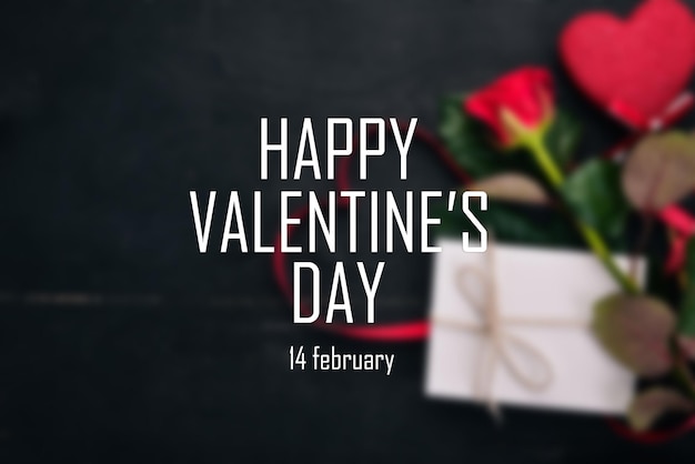 Blurred background. Banner with the words "happy Valentine's Day". Top view. Black background.