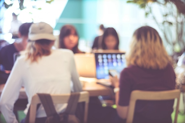 Photo blurred background : blur group of people team meeting at co-working space