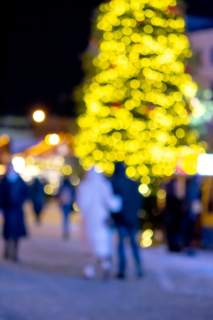 Blurred background Christmas tree decorated glowing lights building