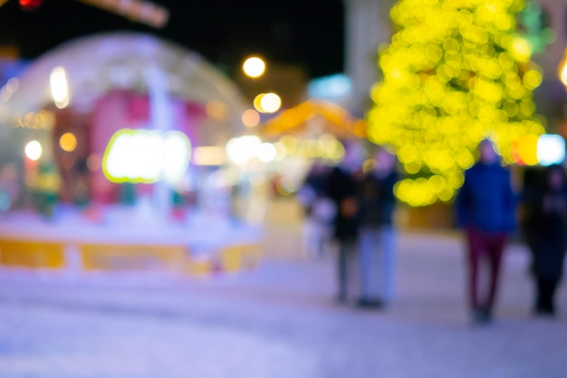 Blurred background Christmas tree decorated glowing lights building