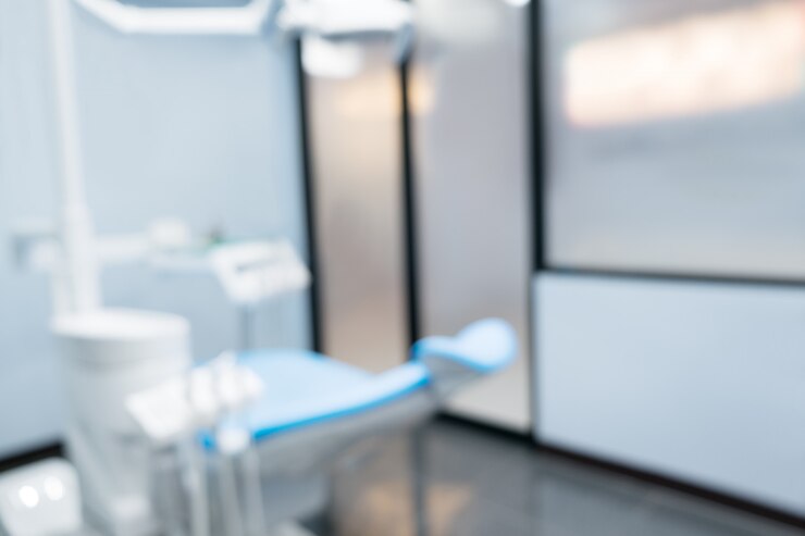 Blurred background. Dentist chair in office or clinic.