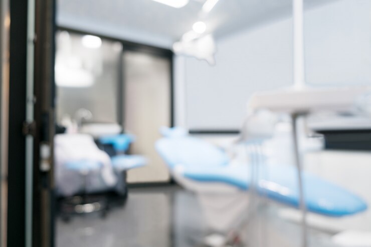 Blurred background. Dentist chair in office or clinic.
