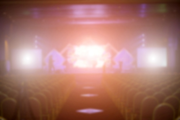 Blurred background of event concert or award ceremony with lighting at conference hall