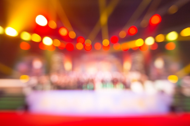 Photo blurred background of event concert or award ceremony with lighting at conference hall
