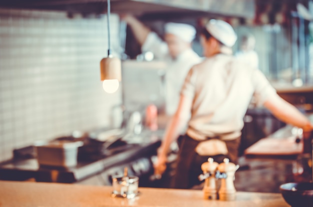 Blurred background  group of chefs cooking in the kitchen