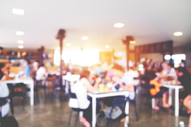 Blurred background image of coffee shop. abstract blur background with people in cafe. vintage color tone style